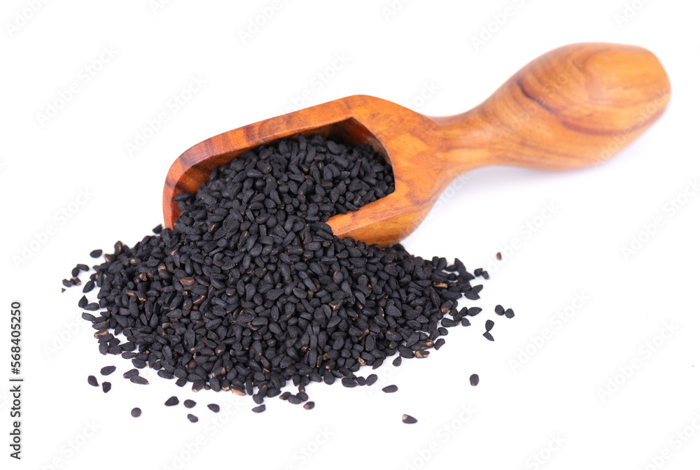 Black cumin seeds in wooden spoon, isolated on white background. Heap of black nigella seeds. Nigella sativa. Black cumin seeds in wooden spoon, isolated on white background. Heap of black nigella seeds. Nigella sativa.