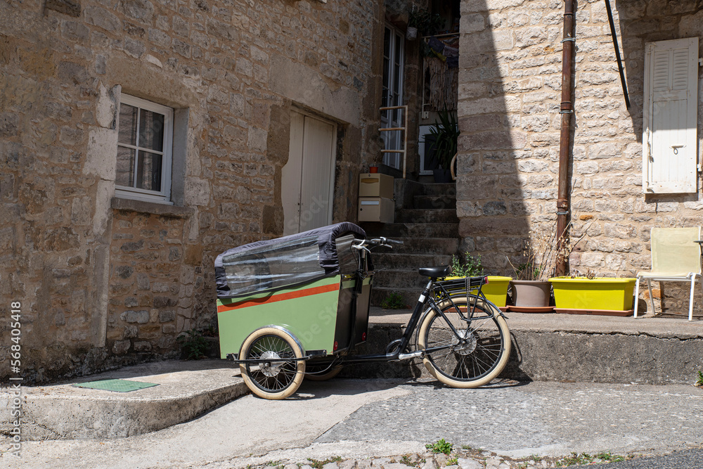 Green cargo bike parked in town