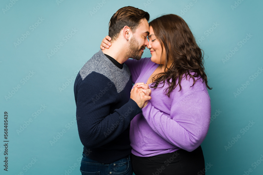 Lovely young couple in love hugging and holding hands Lovely young couple in love hugging and holding hands
