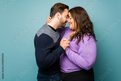 Lovely young couple in love hugging and holding hands