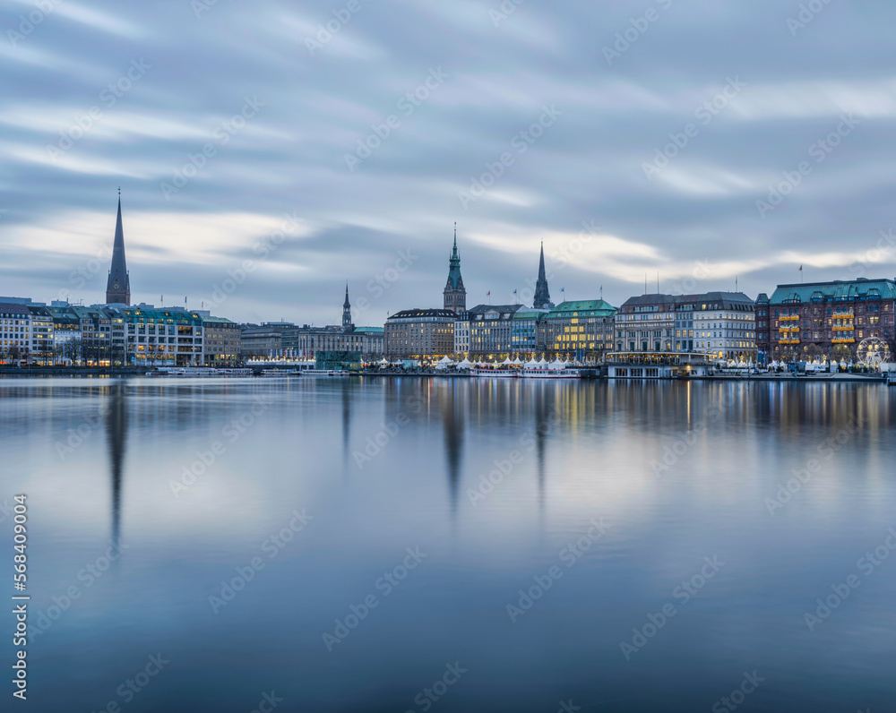 Hamburg city centre illuminated with lights on lake Binnenalster during christmas, Germany