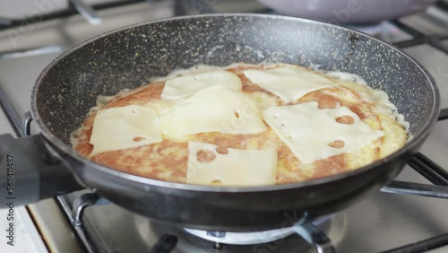 Wallpaper Mural A man making an omelet in the kitchen, timelapse. Omelet with cheese, ham, peppers and arugula. Fast preparing breakfast or lunch in a frying pan Torontodigital.ca