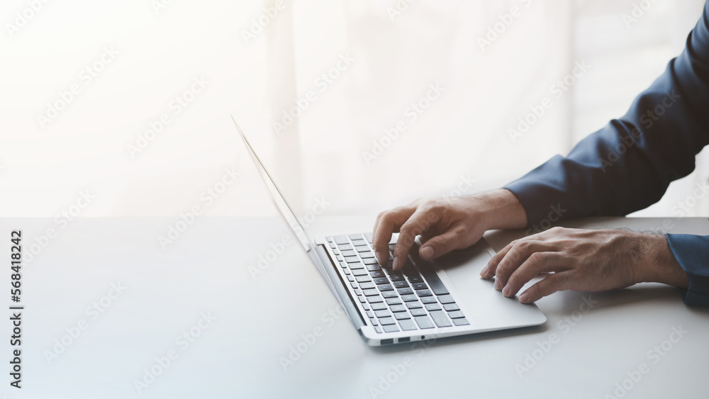 Person typing on laptop keyboard, businessman working on laptop, he is typing messages to colleagues and making financial information sheet to sum up the meeting. Person typing on laptop keyboard, businessman working on laptop, he is typing messages to colleagues and making financial information sheet to sum up the meeting.