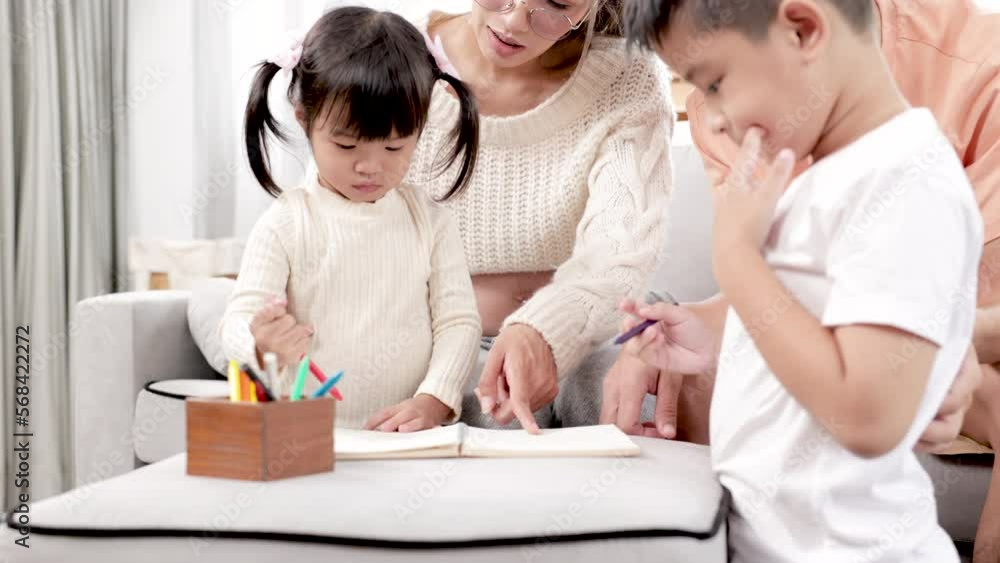4K, Beautiful Asian pregnant mother, do leisure activities on family day with children, mother teaches youngest daughter eldest son, drawing painting, father sits watches children play with mothers. 4K, Beautiful Asian pregnant mother, do leisure activities on family day with children, mother teaches youngest daughter eldest son, drawing painting, father sits watches children play with mothers.