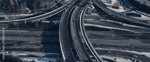 Aerial view of a freeway intersection Snow-covered in winter.Busy intersection. Birds eye view from drone. Cityscape