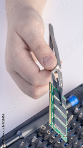 Technician fixing computer. Repair and upgrade concept of laptop. Workshop background