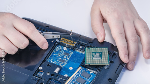 Technician fixing computer. Repair and upgrade concept of laptop. Workshop background