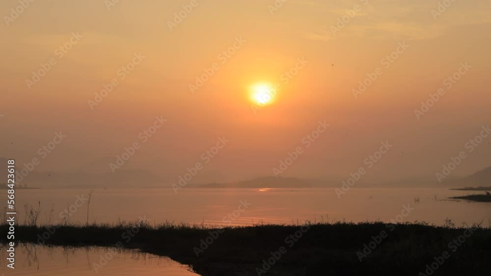 Spectacular sunrise over the lake and the way of life of people and the living of birds at the waterfront Spectacular sunrise over the lake and the way of life of people and the living of birds at the waterfront