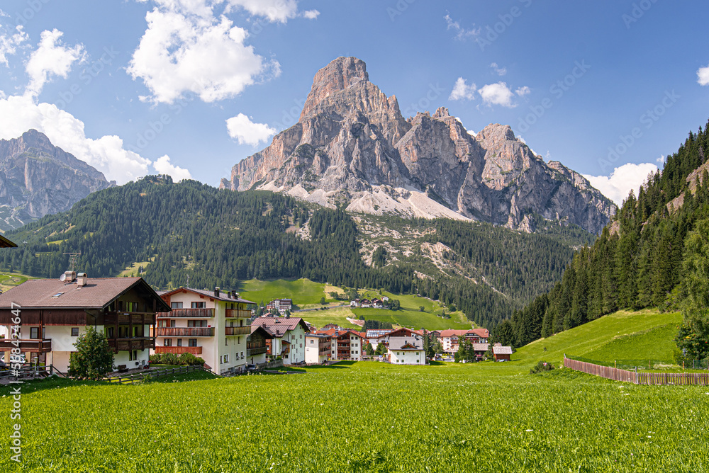 Corvara village and Sassongher mountain as seen from the village below, Val Badia, Dolomites, South Tyrol, Italy