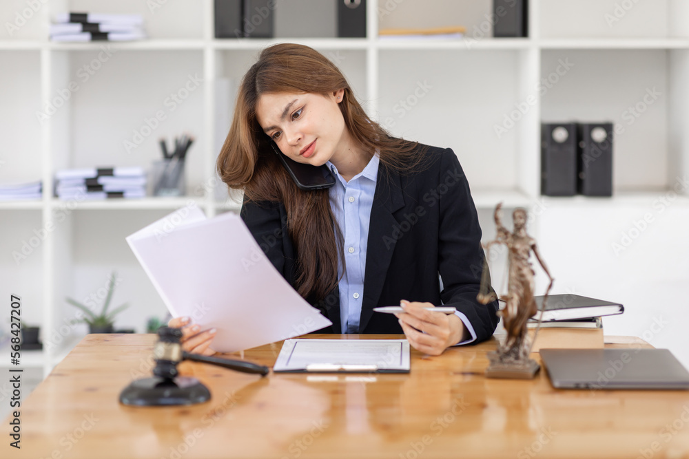female business woman lawyers working and call phone at the law firms. Judge gavel with scales of justice. Legal law, lawyer, documents, advice and justice concept. female business woman lawyers working and call phone at the law firms. Judge gavel with scales of justice. Legal law, lawyer, documents, advice and justice concept.