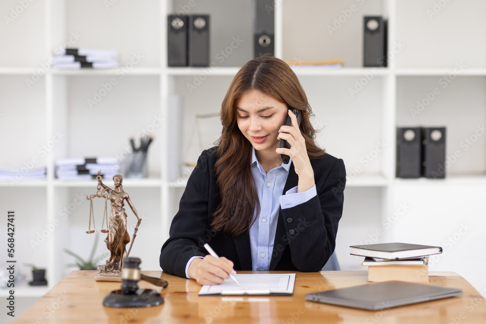 female business woman lawyers working and call phone at the law firms. Judge gavel with scales of justice. Legal law, lawyer, documents, advice and justice concept. female business woman lawyers working and call phone at the law firms. Judge gavel with scales of justice. Legal law, lawyer, documents, advice and justice concept.