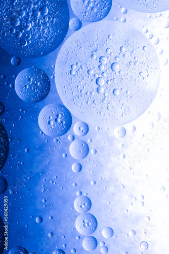 Blue oil bubbles background for cosmetic liquid beauty product. Face serum texture