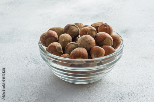 hazelnuts in a bowl on white background photo