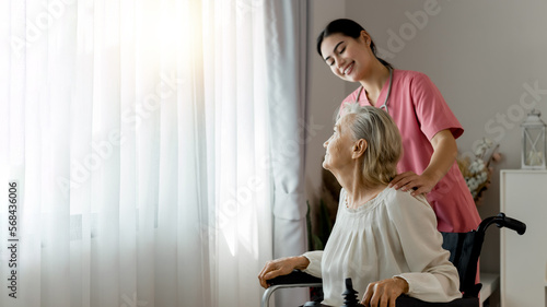 Young professional confident skilled woman doctor visiting old patient lady at home for treatment control care giving. Nurse talking to Caucasian senior patient. Healthcare concept