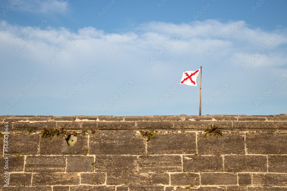 flag on the top of a fort stone wall