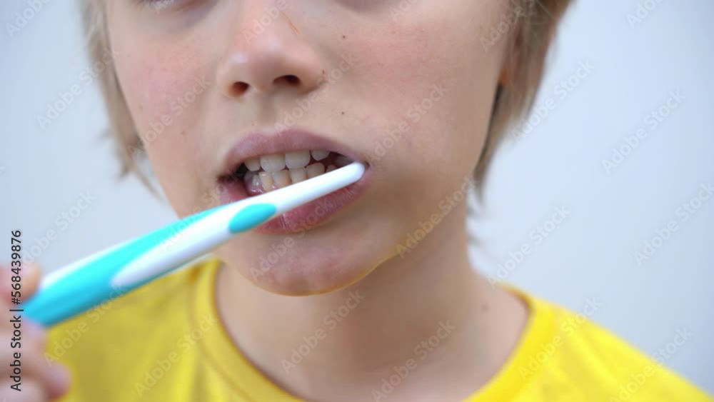 Close-Up Teenager Boy Brush Teeth Child Looking At Camera, Dentistry, Stomatology, Dental Care And Hygiene With Toothbrushes, Morning Evening Routine, Lifestyle, Health Care. Close-Up Teenager Boy Brush Teeth Child Looking At Camera, Dentistry, Stomatology, Dental Care And Hygiene With Toothbrushes, Morning Evening Routine, Lifestyle, Health Care.