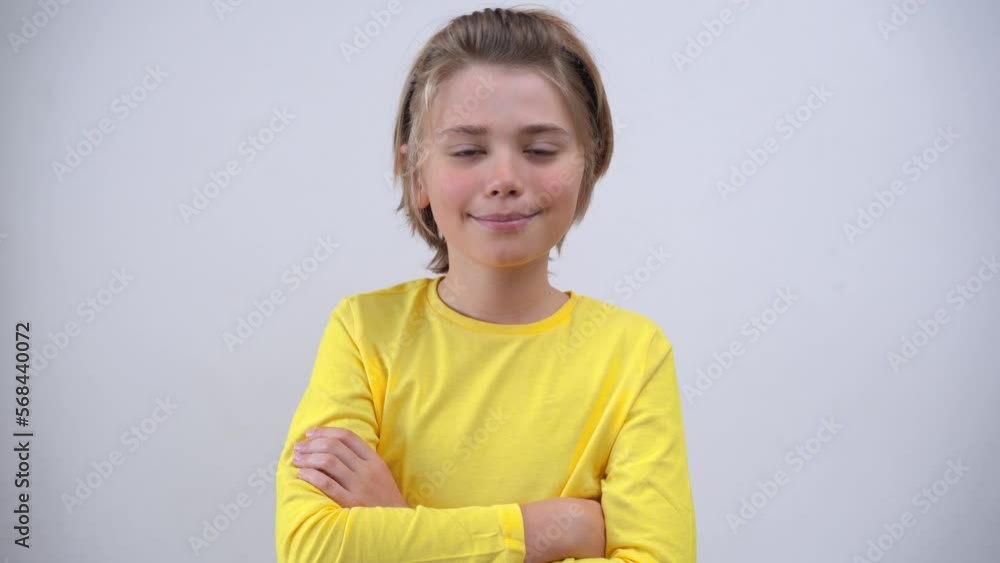 Portrait Of Smiling Handsome SchoolBoy Long Hair in Yellow T-Shirt Looking At Camera Over white Background. Positive Teen Mood. Advertising Copy Space Portrait Of Smiling Handsome SchoolBoy Long Hair in Yellow T-Shirt Looking At Camera Over white Background. Positive Teen Mood. Advertising Copy Space