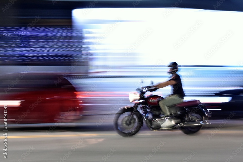 person riding a motorcycle, panning