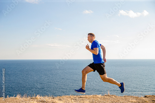 male runner run trail on seashore