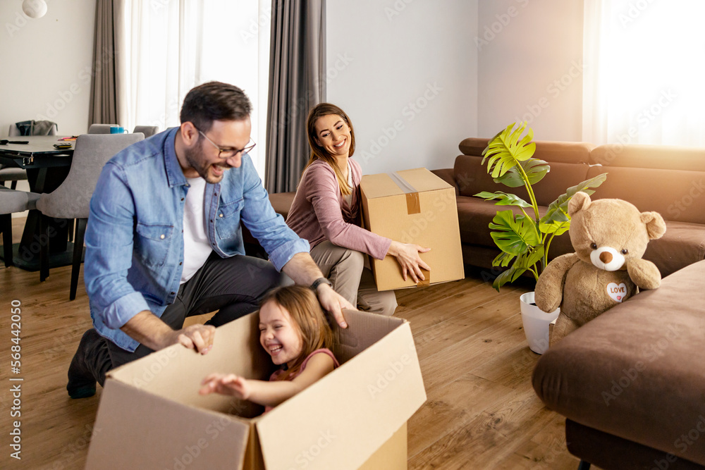 Happy family with child moving with boxes in a new apartment house Happy family with child moving with boxes in a new apartment house