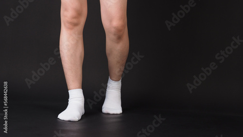 Asian Male split legs wear white sock is isolated on black background