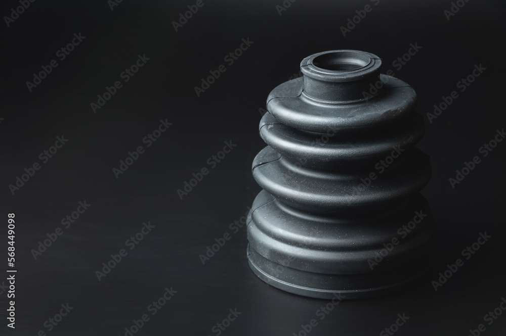 Close-up of a rubber boot on a CV joint on a black background in selective focus