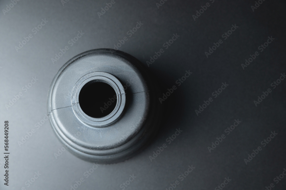 Close-up of a rubber boot on a CV joint on a black background in selective focus