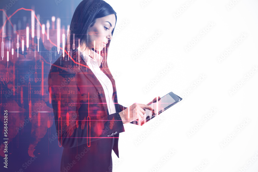 Attractive young european businesswoman using tablet with glowing falling red forex chart on blurry white background with mock up place. Stock exchange and crisis concept. Double exposure.