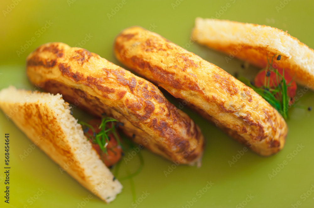 Close-up top view of Spanish omelette with toast slices, cherry tomatoes, and chives. Tortilla de patatas on a neon green plate. Breakfast meal of fried potatoes and eggs. Horizontal food background. Close-up top view of Spanish omelette with toast slices, cherry tomatoes, and chives. Tortilla de patatas on a neon green plate. Breakfast meal of fried potatoes and eggs. Horizontal food background.