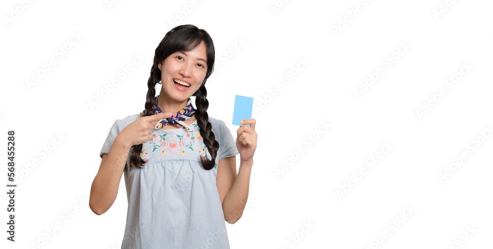 Portrait of beautiful happy young asian woman in denim dress holding credit card on white background Portrait of beautiful happy young asian woman in denim dress holding credit card on white background