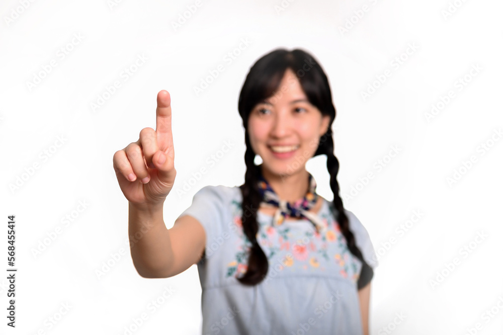 Portrait of beautiful happy young asian woman in denim dress touching invisible screen on white background. Portrait of beautiful happy young asian woman in denim dress touching invisible screen on white background.