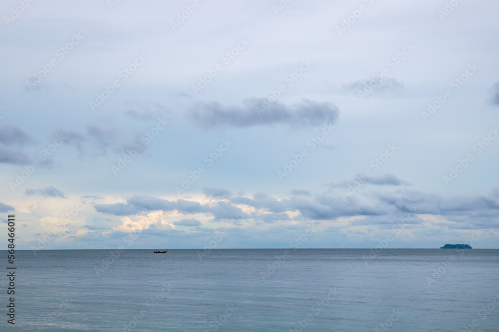 Blue tropical seascape with lone long tail boat and a distant island. Blue tropical seascape with lone long tail boat and a distant island.