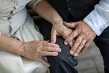hands of elderly people holding hands close up