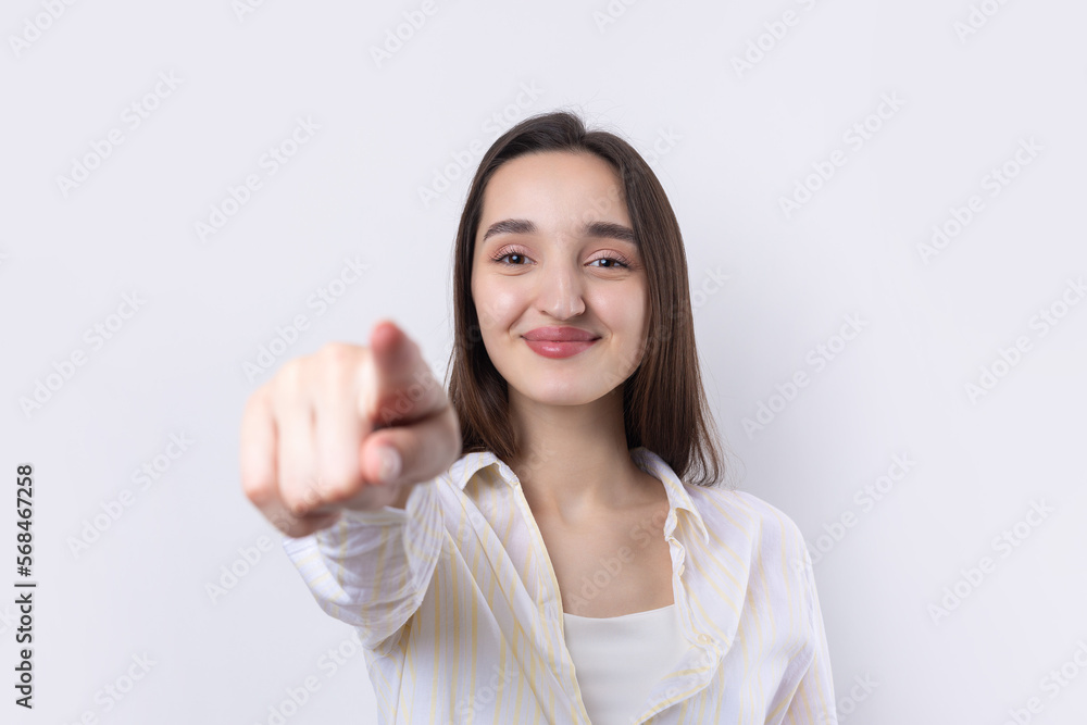Happy young caucasian female in a shirt pointing fingers away Happy young caucasian female in a shirt pointing fingers away