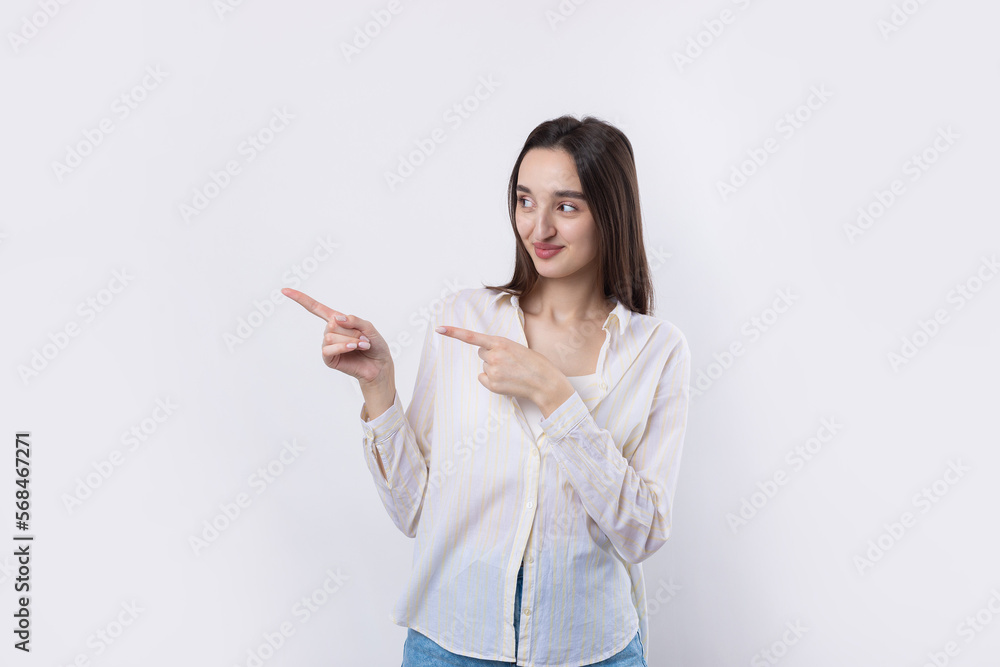 Happy young caucasian female in a shirt pointing fingers away Happy young caucasian female in a shirt pointing fingers away