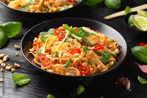 Chicken Pad Thai with eggs, bean sprouts, peanuts and spring onion photo