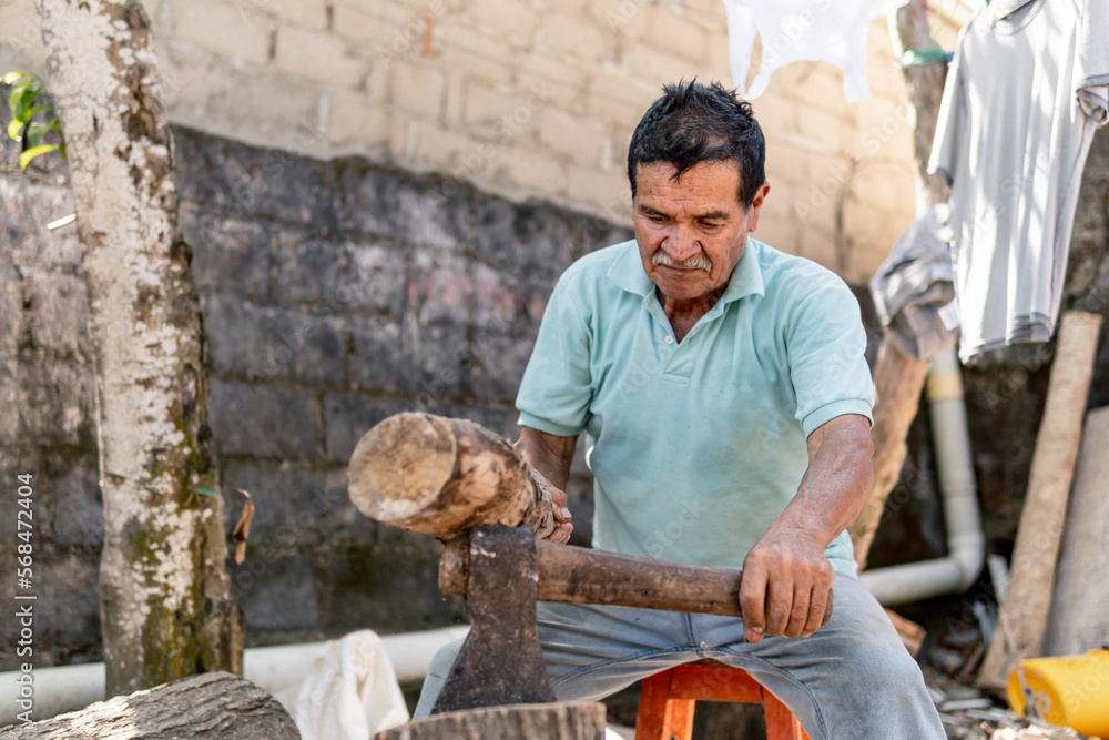 old man cutting with ax wooden spoons in the house old man cutting with ax wooden spoons in the house