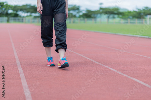 beautifull sport girl exercise at the track court and wearing blue sport bra