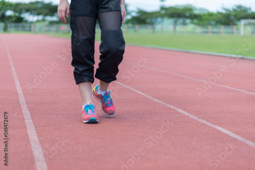 beautifull sport girl exercise at the track court and wearing blue sport bra