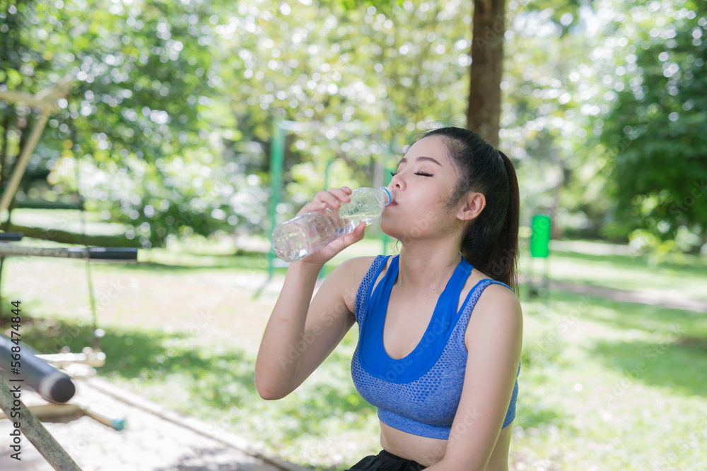 beautifull sport girl drinking water at the public park court and wearing blue sport bra beautifull sport girl drinking water at the public park court and wearing blue sport bra