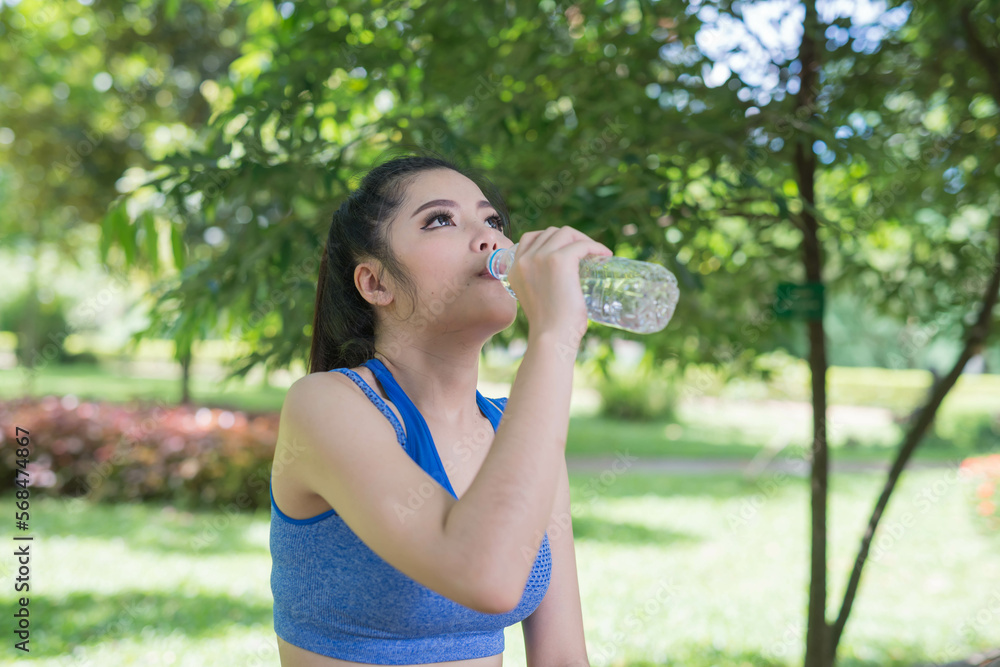 beautifull sport girl drinking water at the public park court and wearing blue sport bra beautifull sport girl drinking water at the public park court and wearing blue sport bra