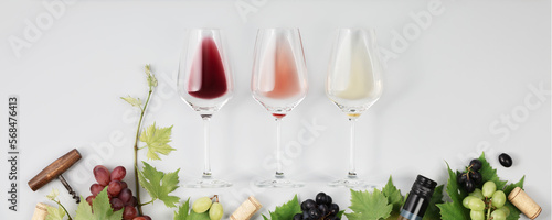 Banner. Flat-lay of red, rose and white wine in glasses on white background photo