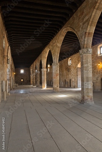 Stone arches inside building with wooden ceiling  Old Town of Rhodes  Greece.