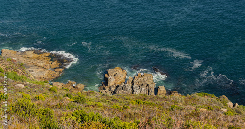 Steep cliffs and turquoise sea at the Cape of Good Hope in South Africa