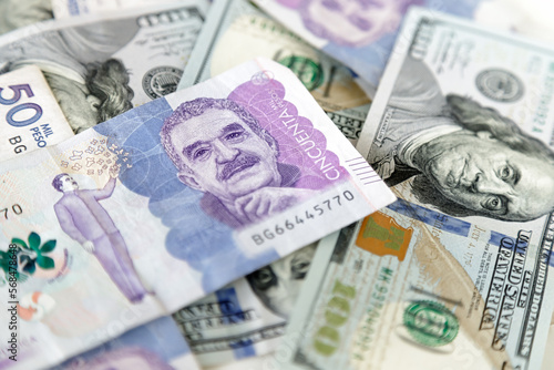 Macro closeup of 50 thousand Colombian pesos bills and 100 dollar bills