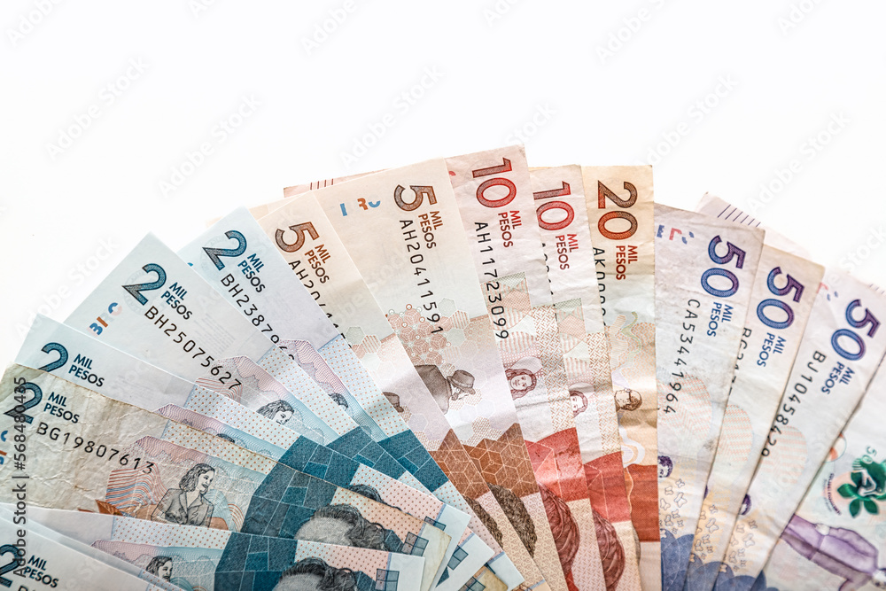 Colombian pesos of different value in the shape of a fan on a white background Colombian pesos of different value in the shape of a fan on a white background