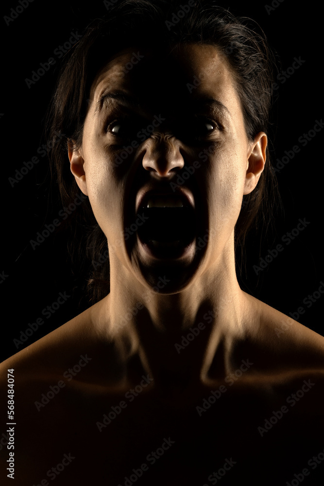 Fototapeta premium Silhouette of young unhappy woman on black background