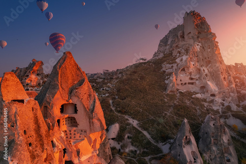 Sunset landscape Cappadocia Aerial view. Color hot air balloons fly background ancient Uchisar castle, Turkey Goreme national park