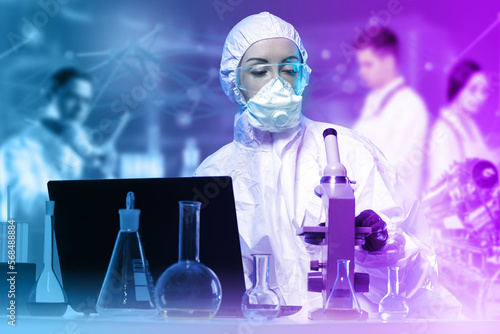 Woman chemist. Scientific laboratory employee with microscope. Chemist girl uses electron microscope. Man in chemical protection suit. Biologist woman sitting at table with test tubes and laptop