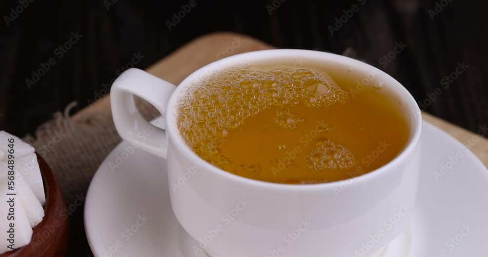 brewing a tea bag with hot boiled water, making tea using a tea bag during breakfast brewing a tea bag with hot boiled water, making tea using a tea bag during breakfast